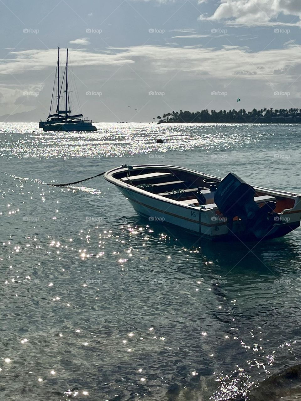 Boats moored in the Caribbean Sea with the reflections of the sun