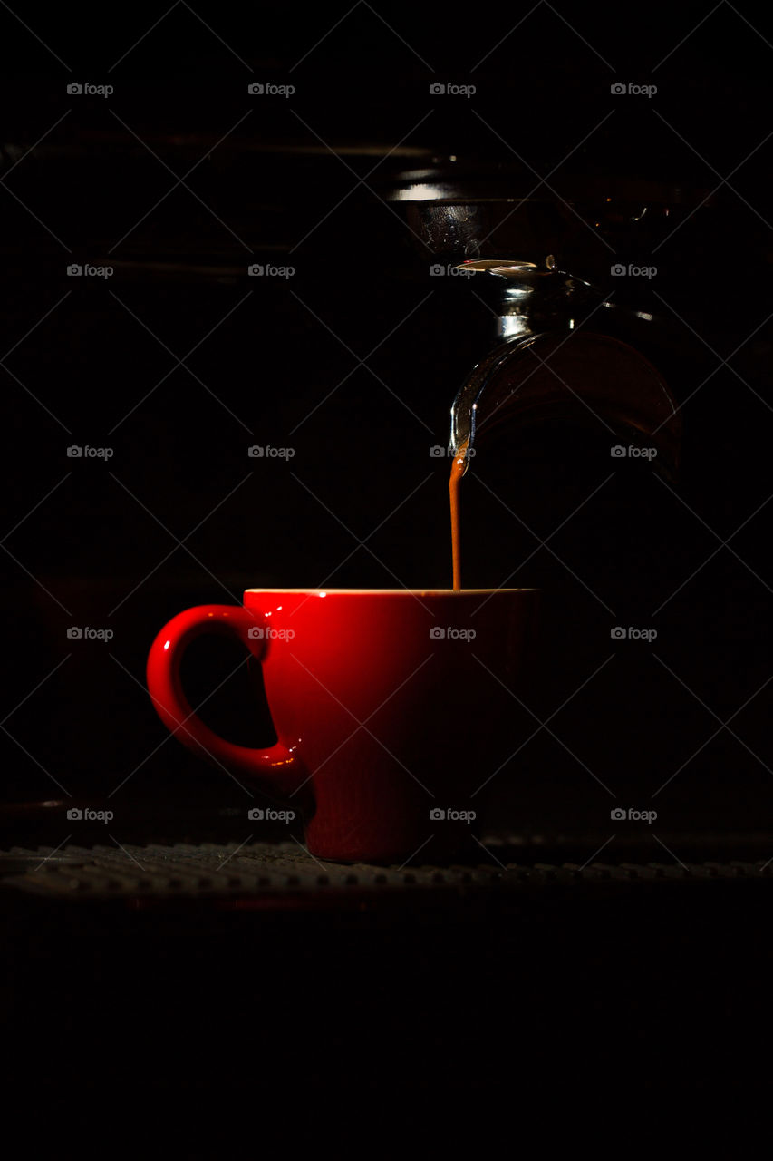 Shot of espresso pouring into a red espresso cup. I love freshly made coffee!