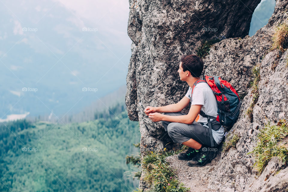 Boy resting on a rock in The Tatra Mountains