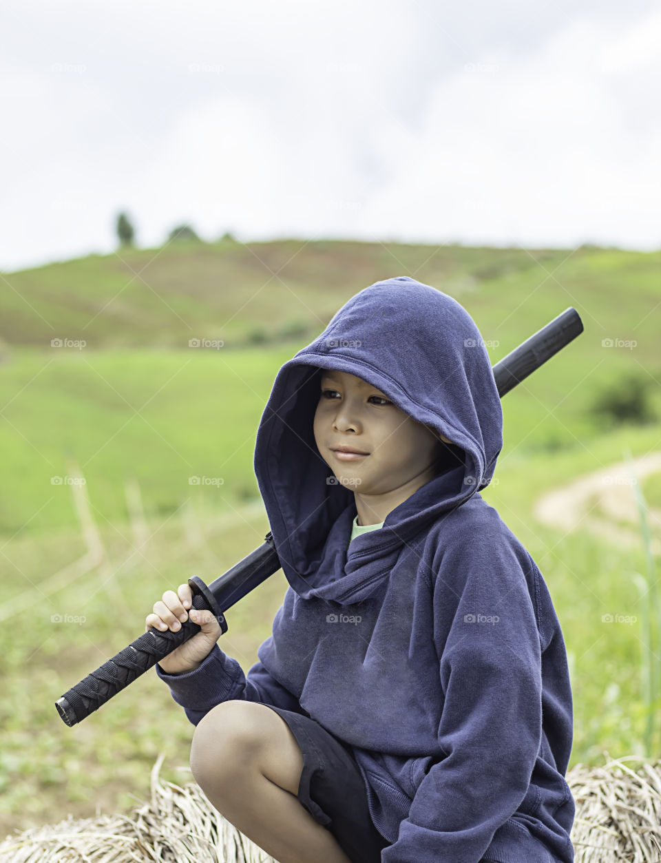 Portrait of a boy holding a wooden sword play.