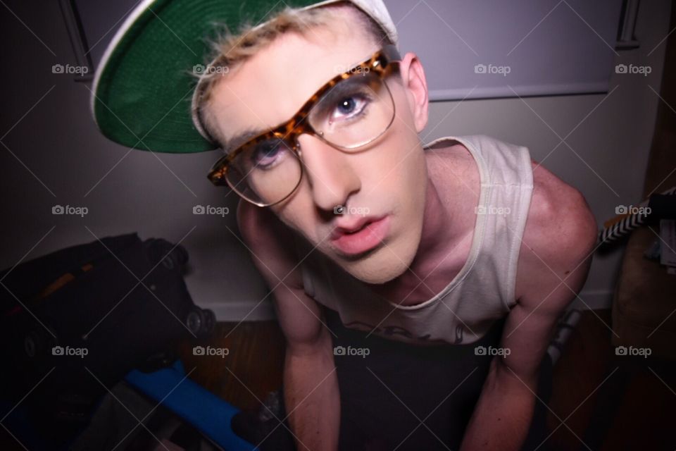 Close up Trendy. Trendy guy with a piercing and glasses being urban with his selfies.