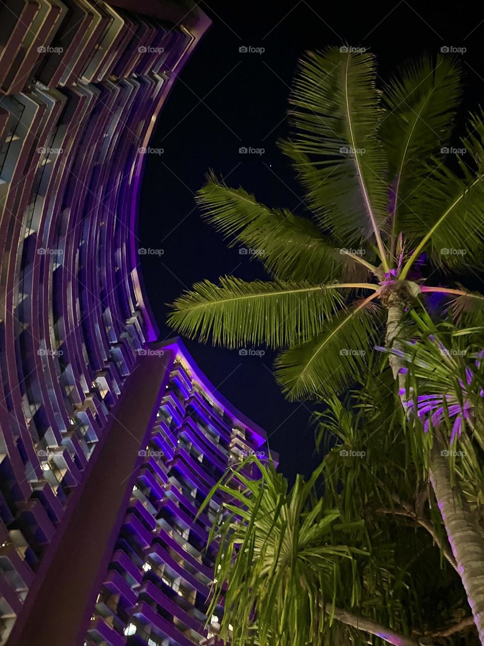 Looking up at the Sheraton hotel in Waikiki at night 