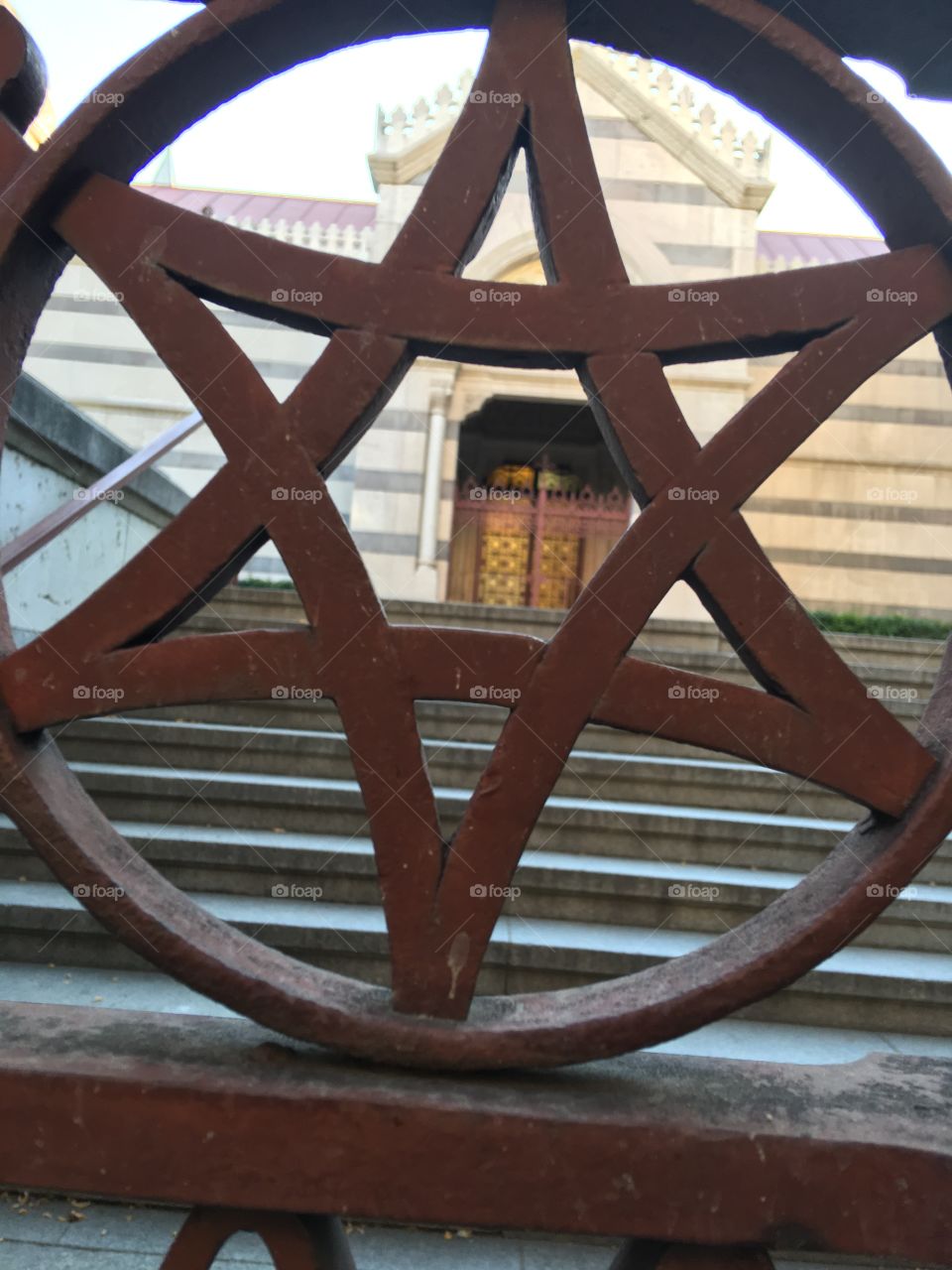 Views of church through iron fence 