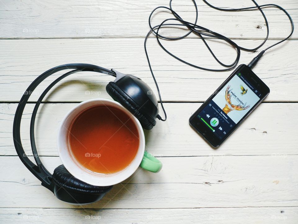 Cup of tea, smartphone and headphones