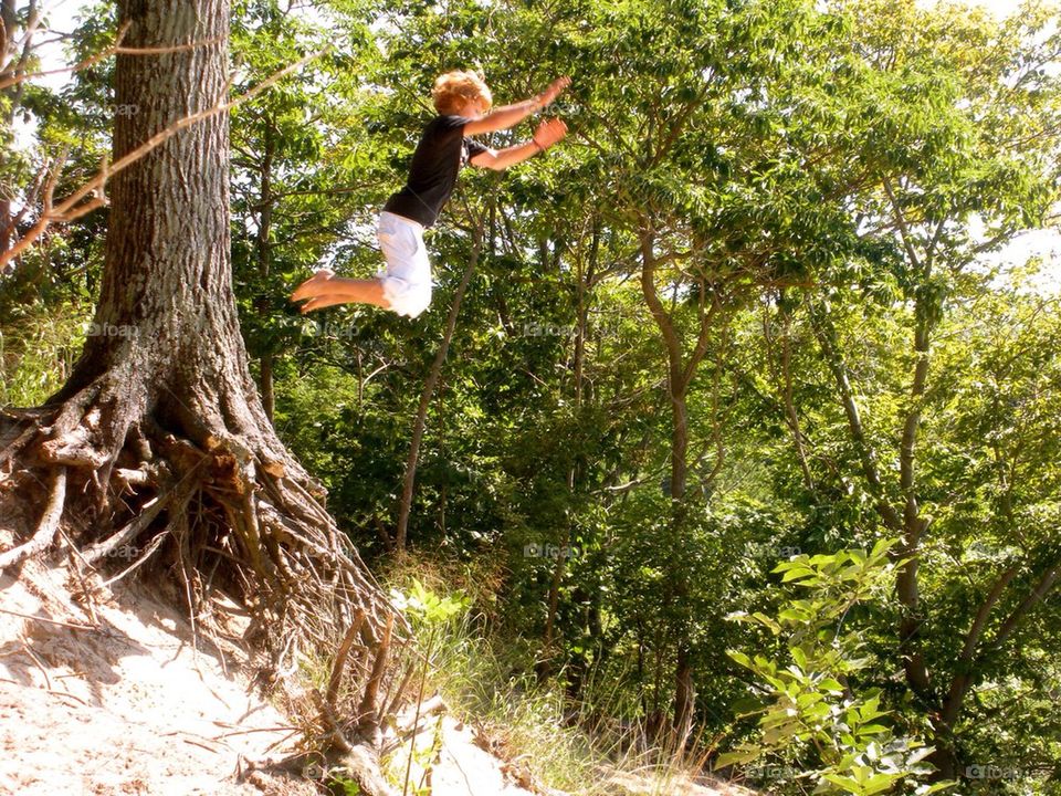People hiking. Jumping from a tree