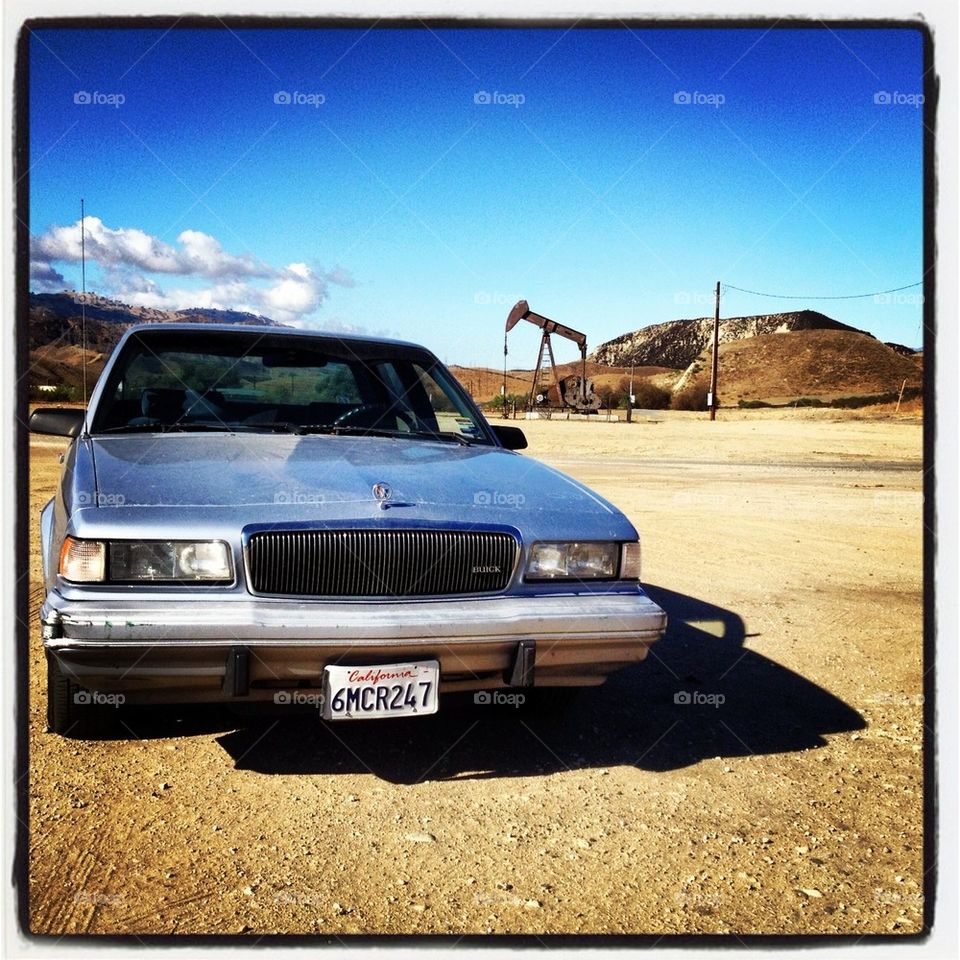 Car near oil Derrick 