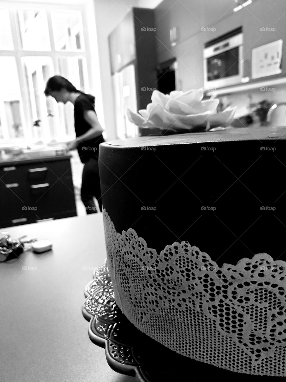 Black and white cake in a kitchen.