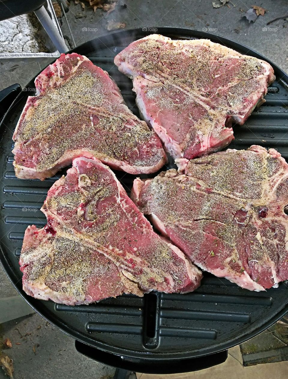 t-bone steaks on an electric grill seasoned to perfection
