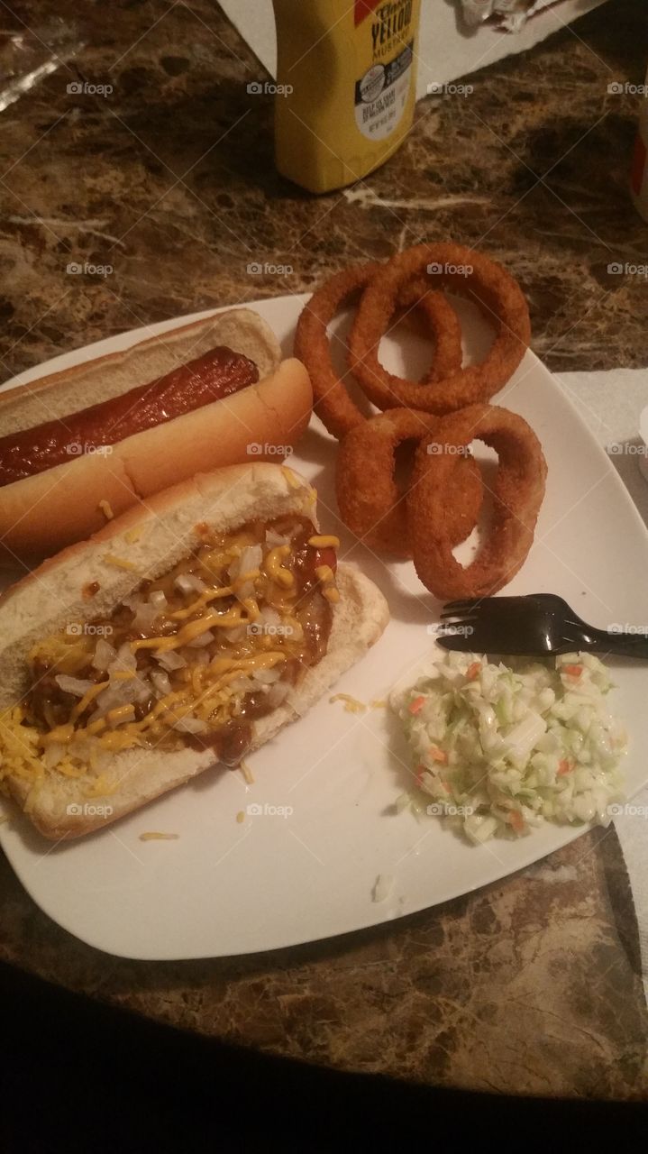 hot dog, chili dog, onion rings and coleslaw