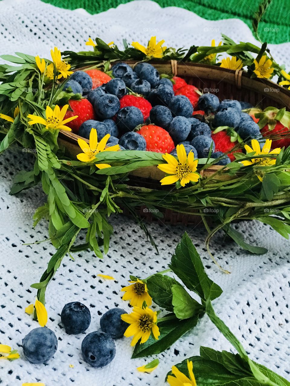 Blueberries and strawberry with yellow flower basket