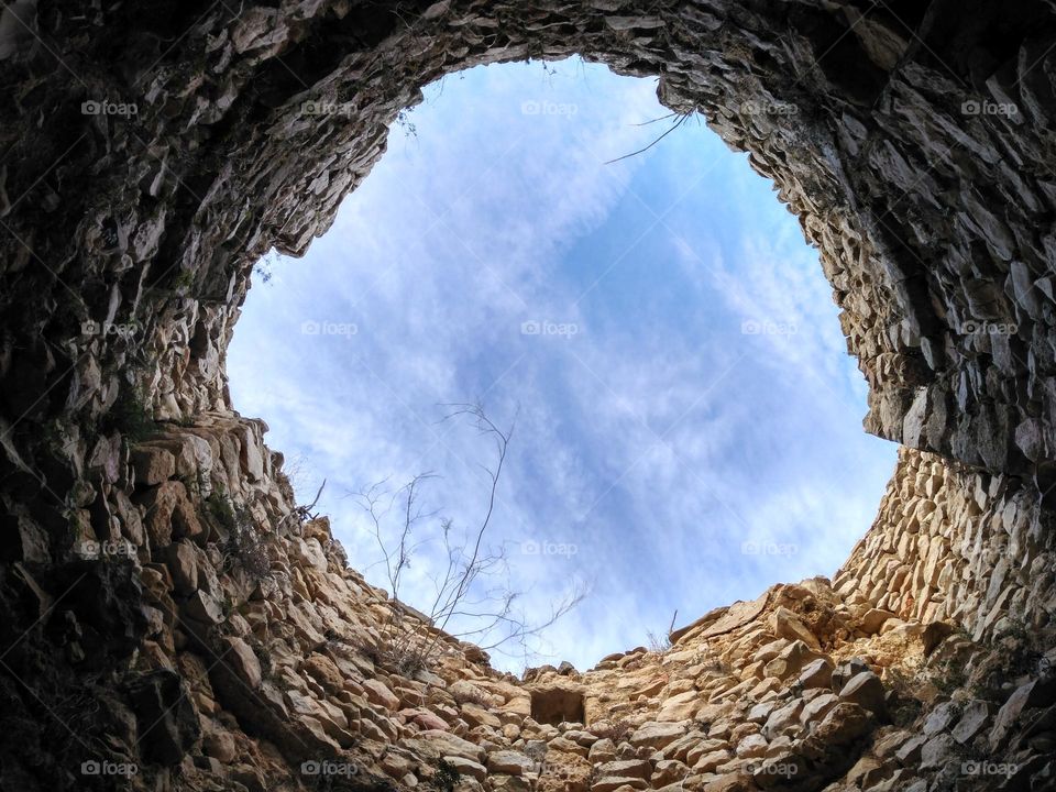 Inside the mill w- Molins de la Plana in Javea, Spain. Surrounded by its roofless stone walls, watching the beautiful sky.