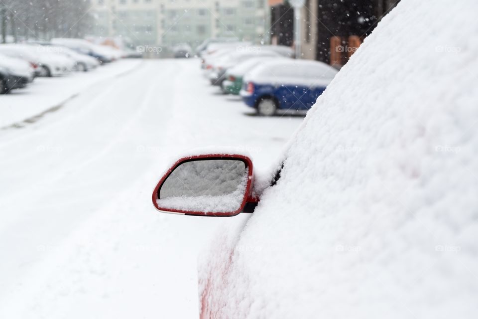Rear car mirror with snow during winter. Slovakia