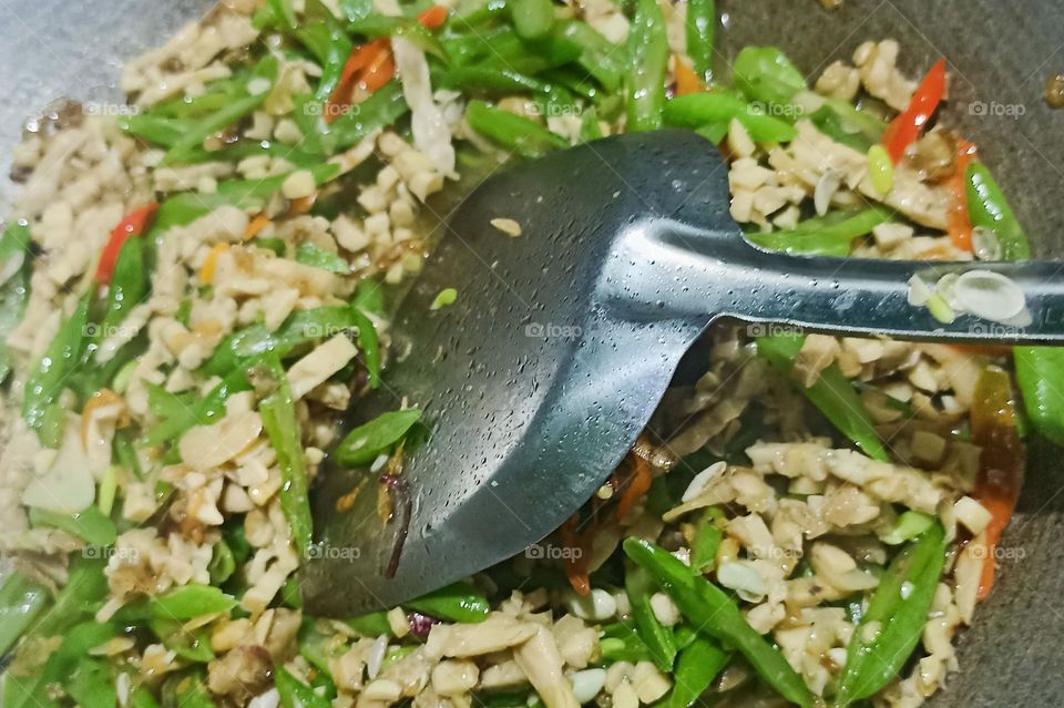 Close-up of stir-fried vegetables and minced meat cooked on a frying pan in high angle view