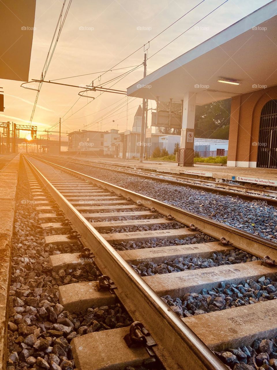 
A quiet station at sunset, with tracks glowing in golden light. The scene captures the beauty of travel and the endless possibilities each train brings.