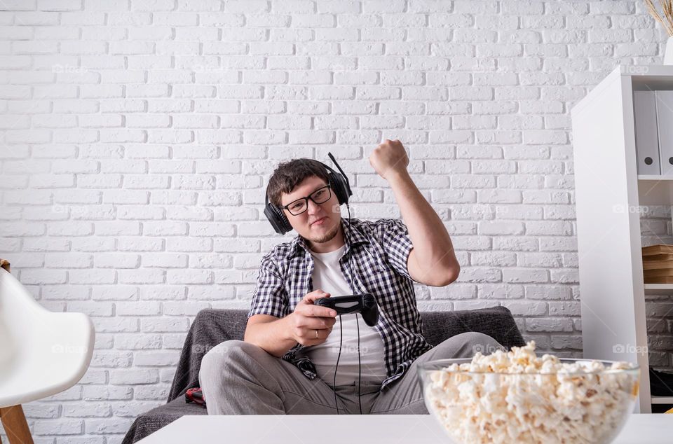 young emotional man playing video games