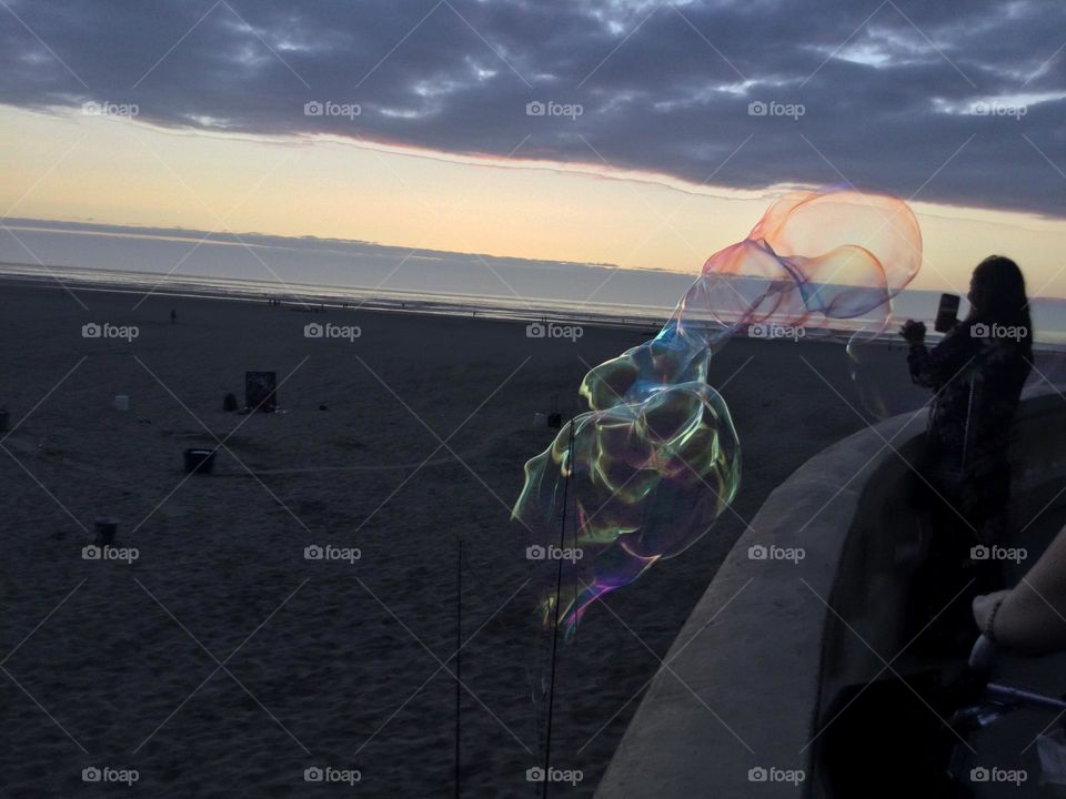 Large Bubbles Being Blown Along the Beach in Seaside Oregon 