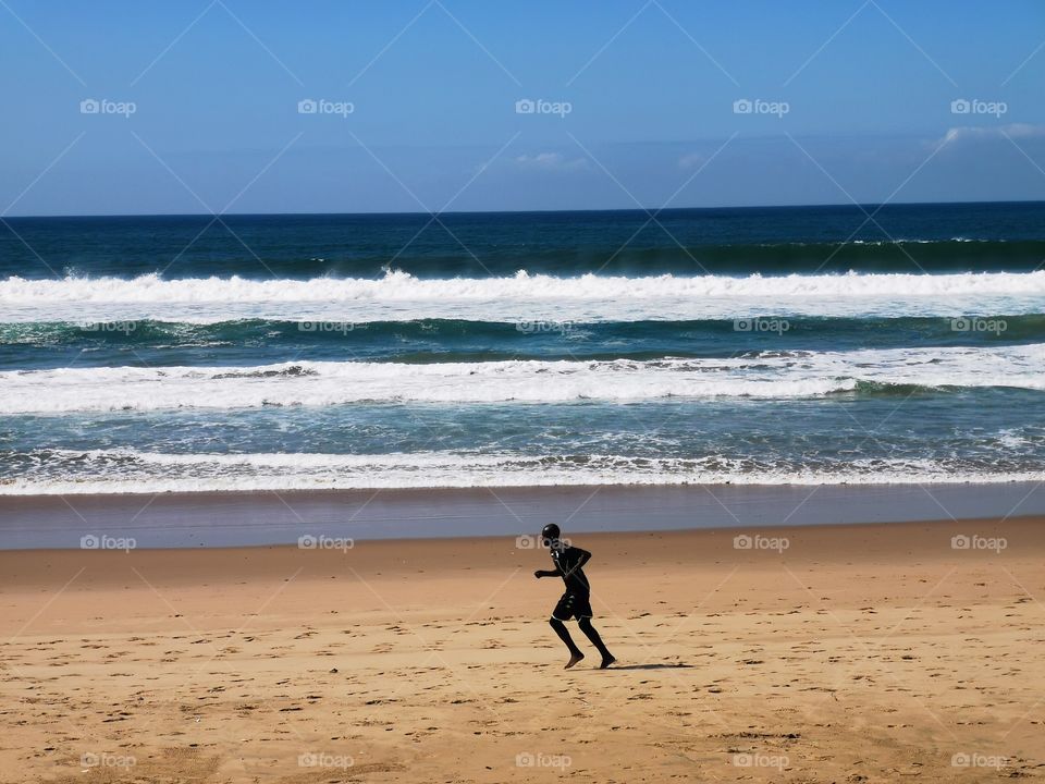 Man jogging on the beach.