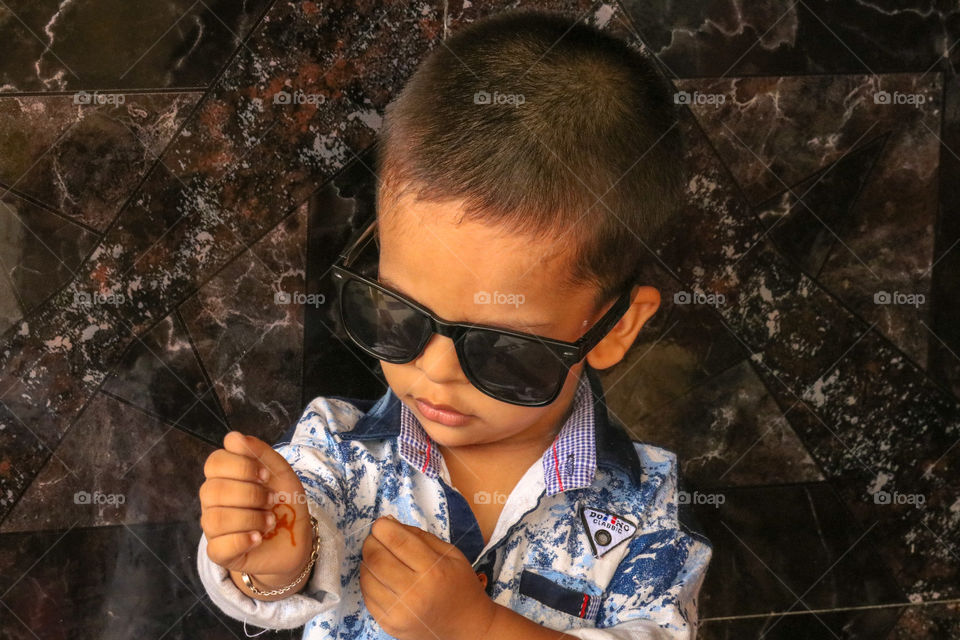 kid with black colour sunglasses