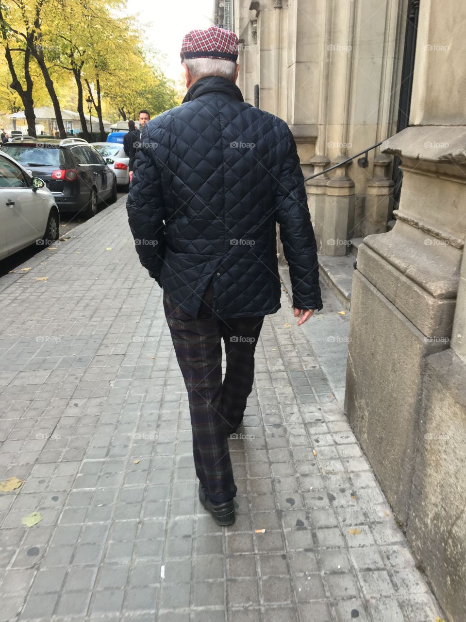 A typical Catalan citizen walking along the avenue in the Eixample district ofBarcelona.