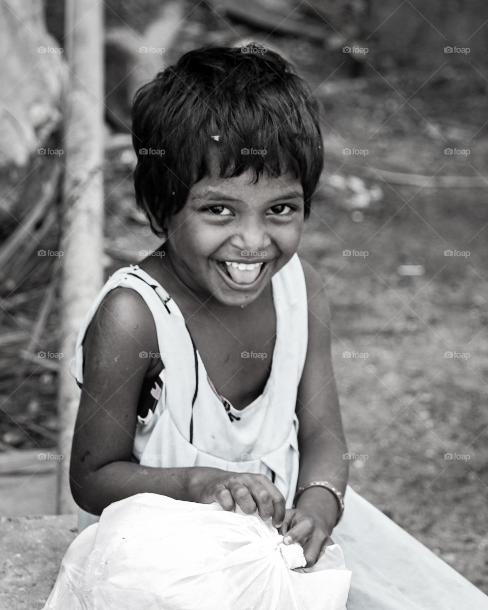 A soulfull emotion that shows painfull smile of indian poor child