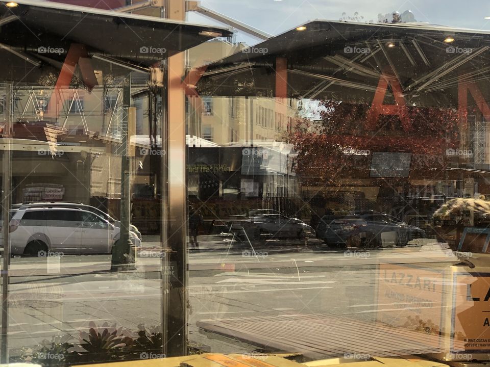 The reflection of Oakland’s buildings through the Whole Foods window in Oakland California 