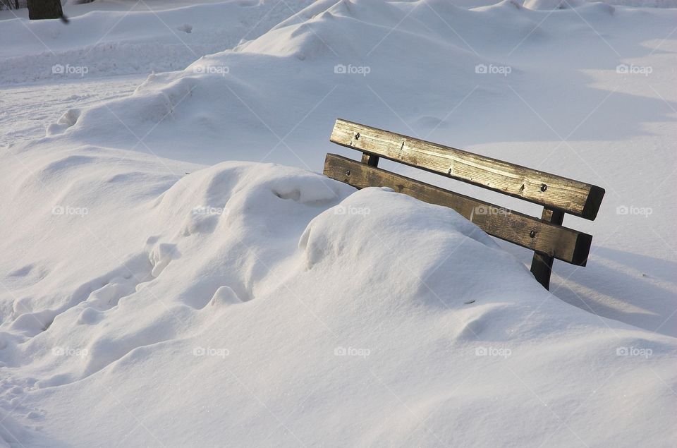 Bench covered with snow