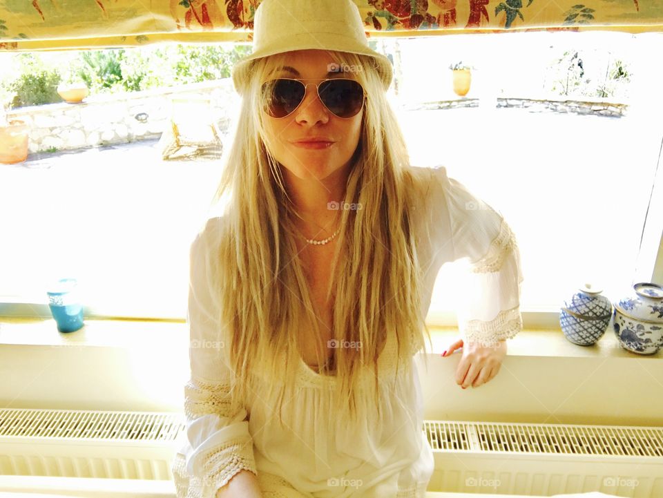 Blonde girl wearing sunglasses and hat