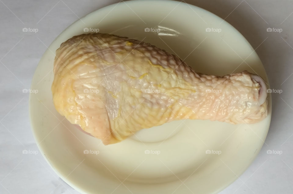 A Chicken Leg In A White Plate