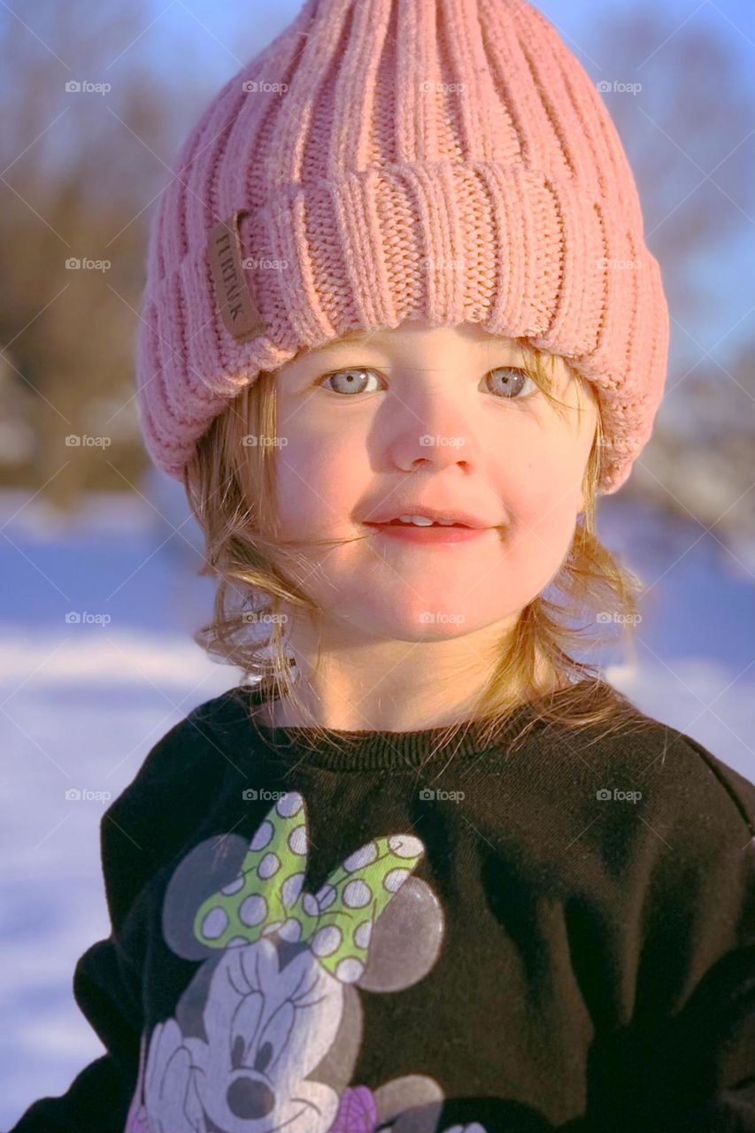 A young girl smiles as she plays in fresh, white snow that has fallen in Mount Juliet, Tennessee 
