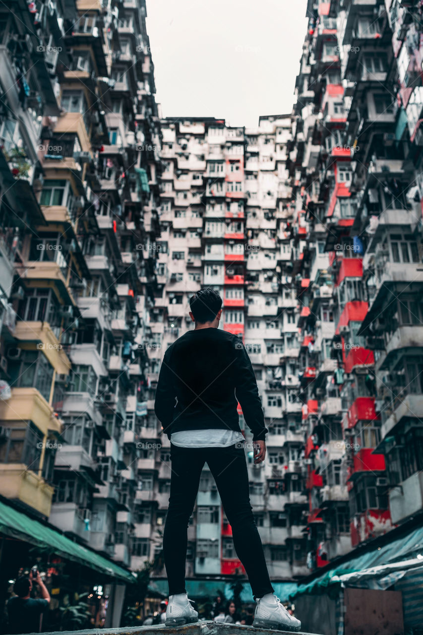 The Best Photo in Hong Kong.

A man is standing in front of a special, dense and packed building called the Monster Building in Hong Kong