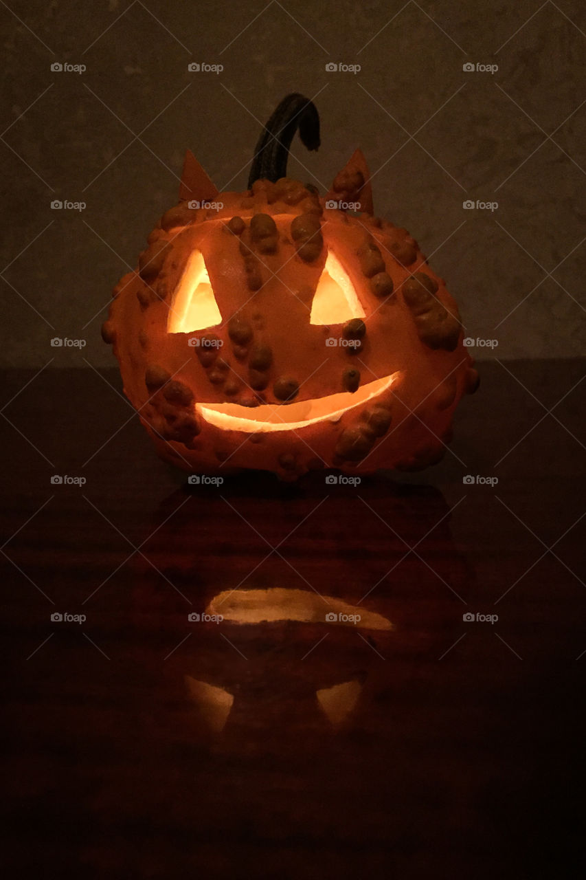 Helloween pumpkin in the dark with reflection