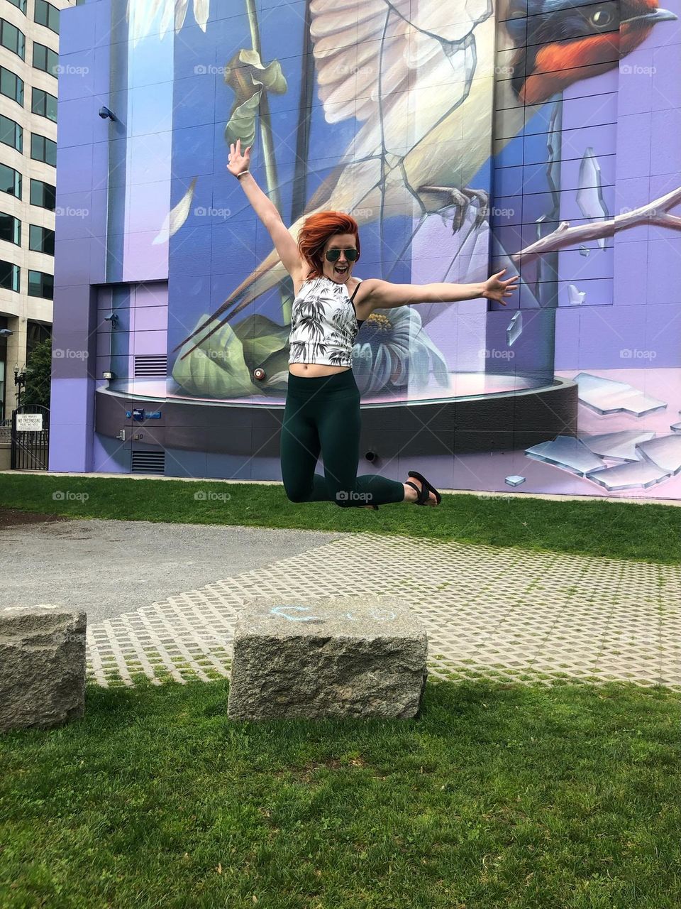 jumping for joy in the city by the mural, Bostons one of many parks near the financial district. 