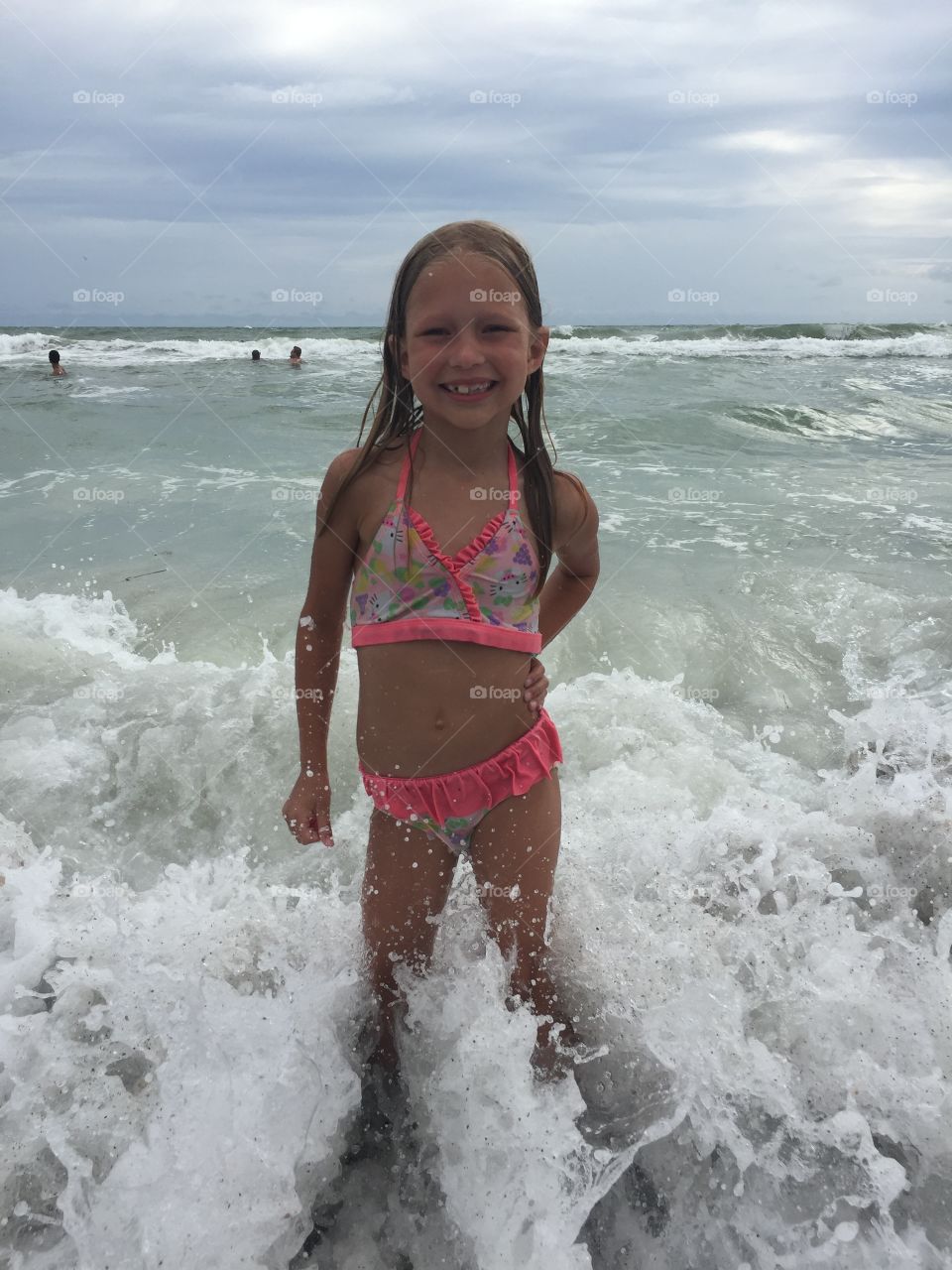 Little girl playing in the ocean 