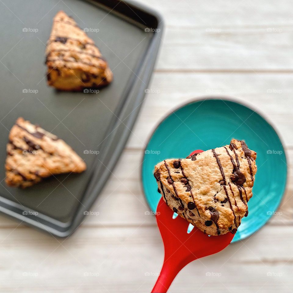 Placing a chocolate chip scone onto a plate, eating freshly baked scones at home, making desserts at home, baking in the kitchen, making scones with toddlers, smartphone food photography, mobile food photography, sweet treats made with love 