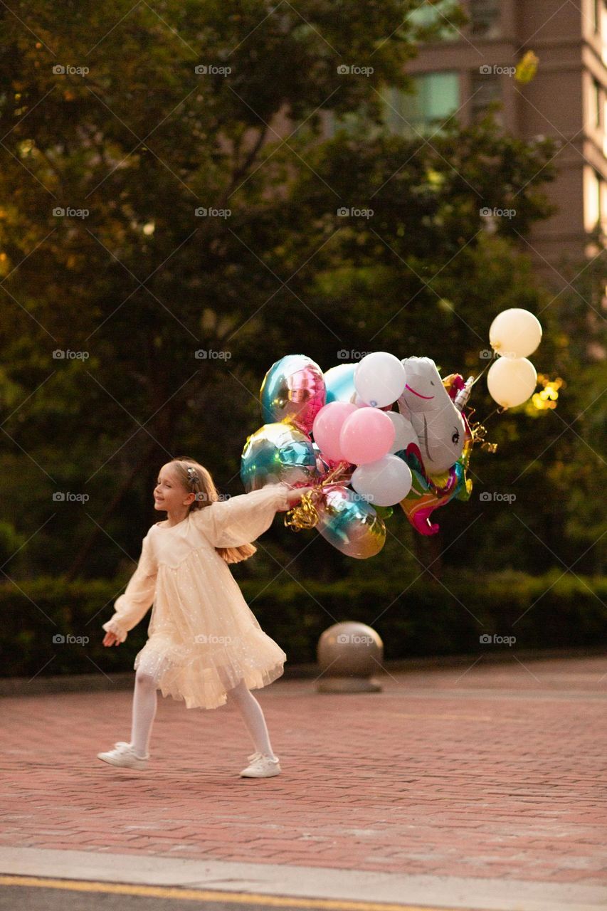 Happy little girl and hot air balloons 