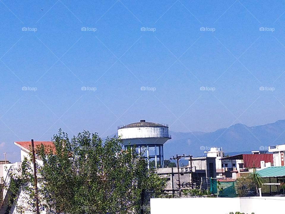 The beautiful Mussoorie hills and an exquisite blue sky providing a wonderful backdrop to the town of Dehradun, the City of Love