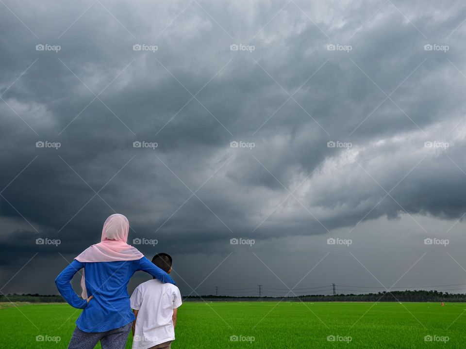 Watching the approaching storm over the rice field in Teluk Intan, Malaysia