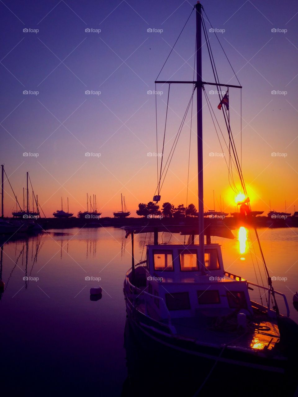 Boats moored at harbor at dusk