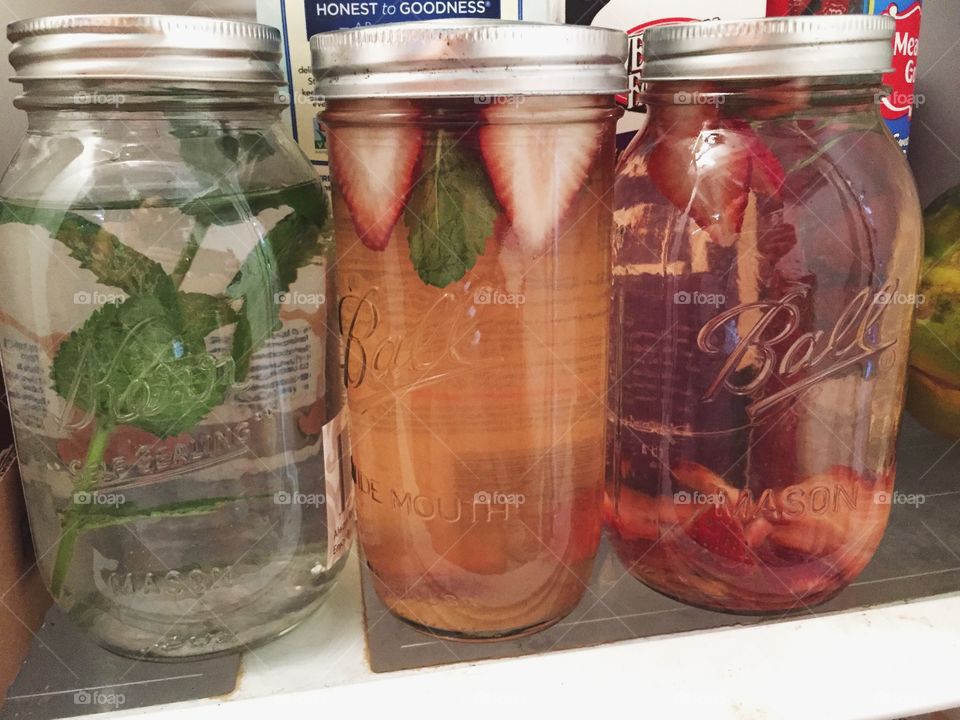 Refreshing flavored water with fruit in mason jars