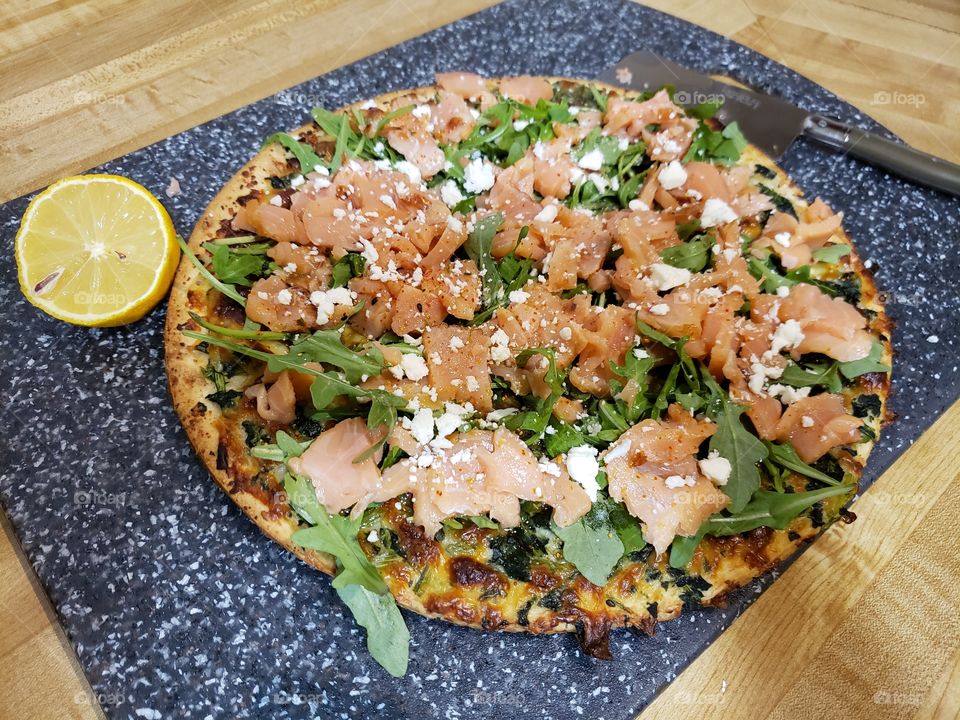 Salmon and arugula pizza