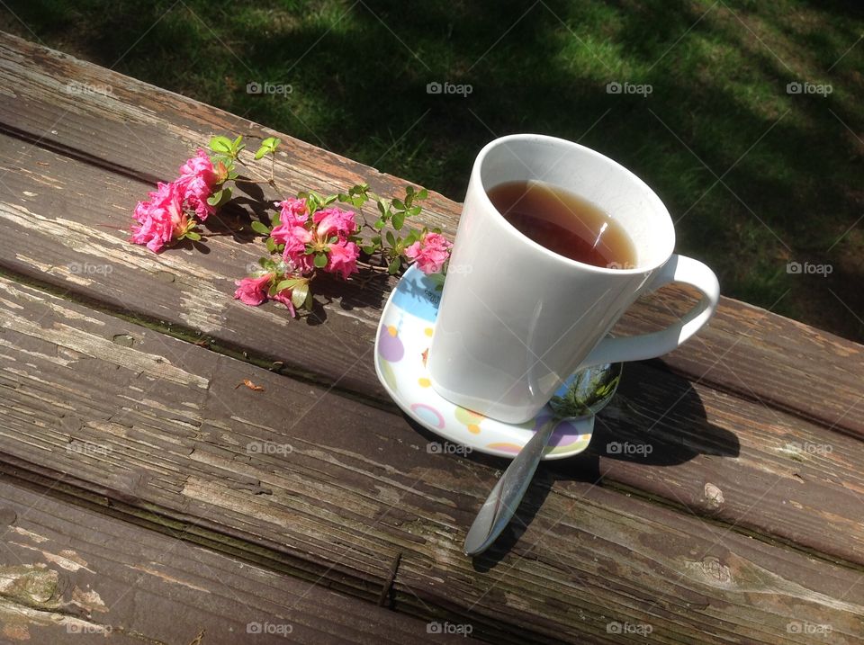 Enjoying a cup of coffee on a beautiful spring day outdoors.