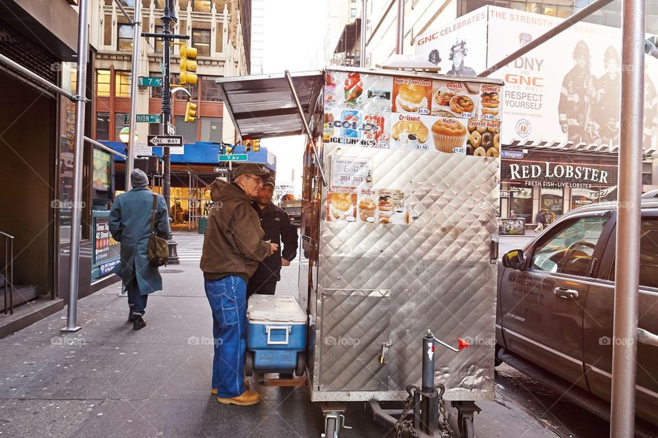 customers buying food at food vendor on street in manhattan