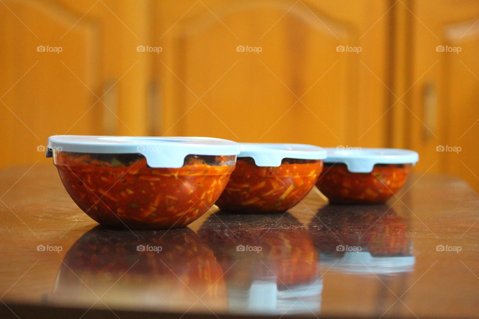 Closed pickled bowls on table