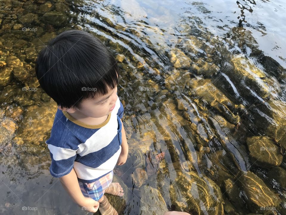 Kid Standing in River Water