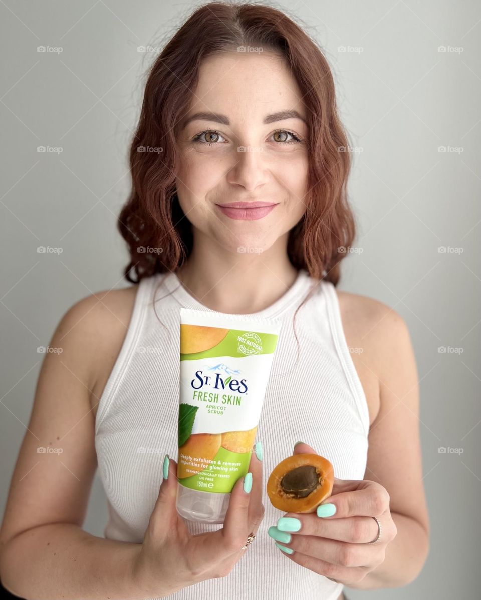 St. Ives fresh skin apricot scrub. Natural cosmetic for everyone. Photo without retouching. Natural beauty. Beautiful smile, beautiful young woman. 