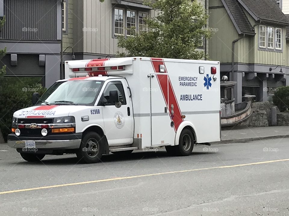 Local ambulance parked on the side of the road as the paramedics tend to a patient in one of the buildings. First responders are amazing.