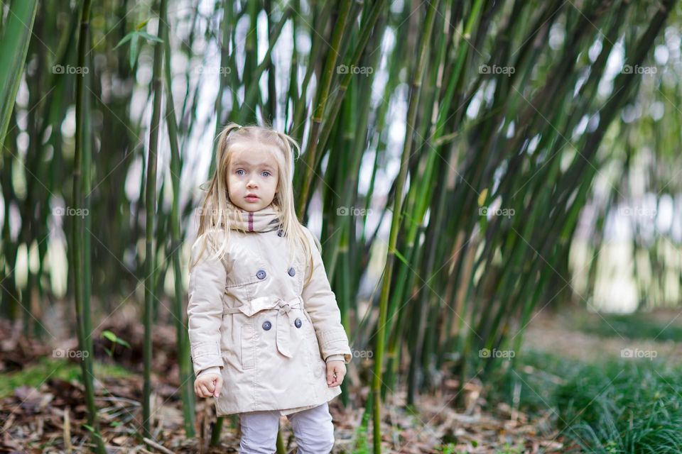 Candid lifestyle portrait of cute little Caucasian girl with surprised face