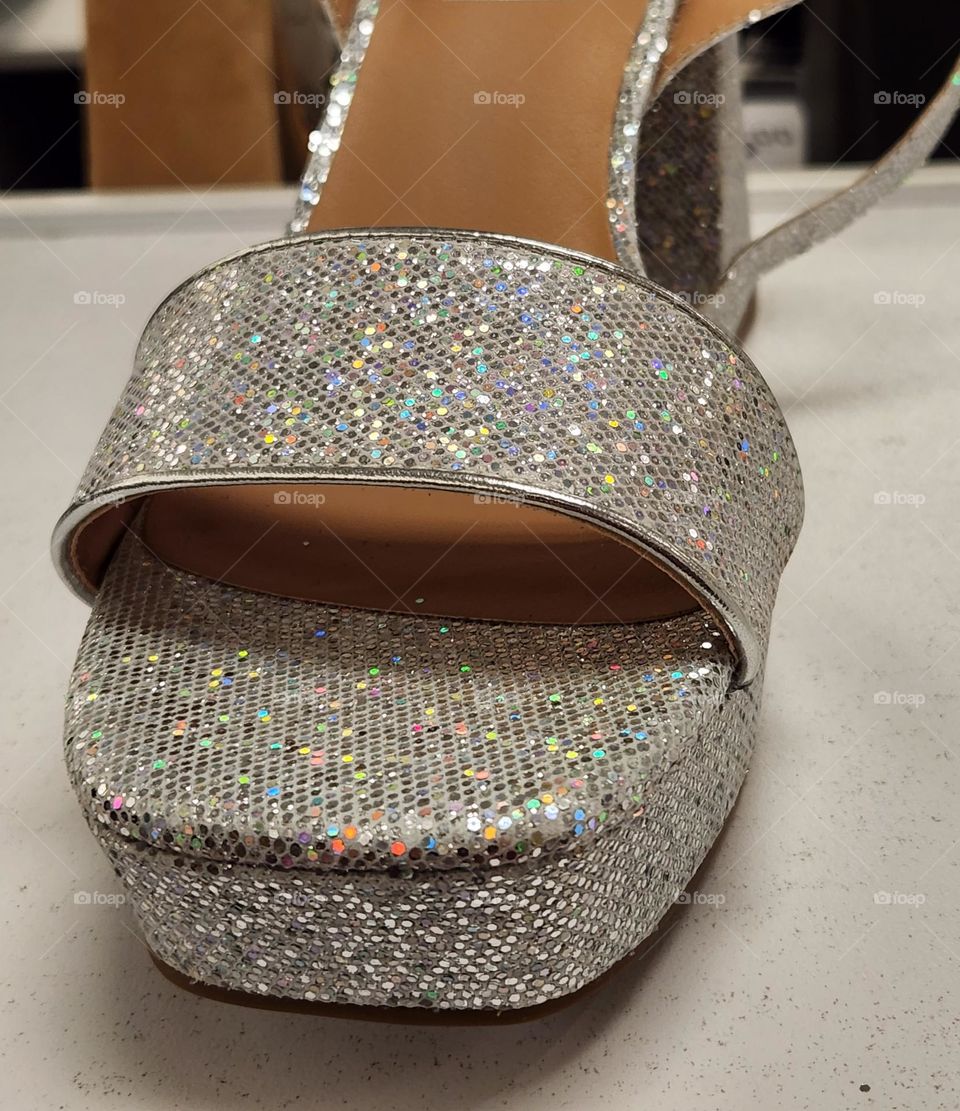 Barbie fashionista style glam sparkly silver open toe high heel shoe close up in a mall store