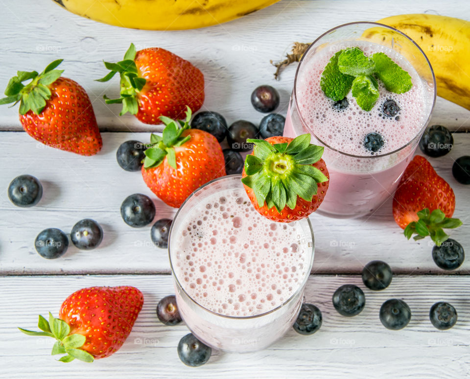 Overhead view of berry and banana smoothies