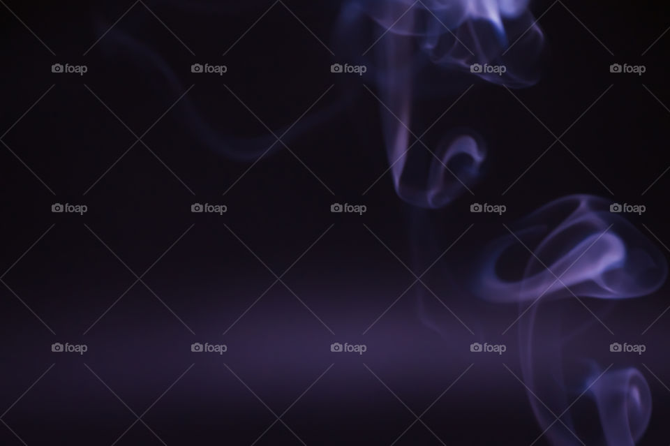 Smoke scented candles on a black background